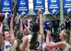 Captain Lydia Sussner held the ball and trophy awarded to Minneota for capturing third place. The others gathered to share in the fun after they beat Mt.Iron-Buhl for third place, 74-56.