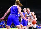 Morgan Hennen drove toward the basket and Goodhue[s Kate Opsahl. Behind her was Arianna Thomforde of Goodhue.