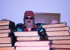 Mark Minnick with a pile of Ole Pappy’s Cosmos newspapers.