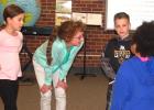 Mary Kaye Rabaey visits with some of her first-grade students before the beginning of class last week.