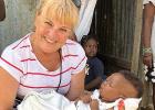Mary Maher holding a Haitian baby. 