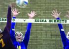 Morgan Hennen (left) strained to get a block against Medford. Abby Rost as also coming to help (right). 