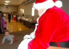  One-year-old Ezekiel Almjeld seemed interested in Santa Claus and crawled near him, but maintained a safe distance on Saturday during the North Pole Extravaganza event at the Legion in Minneota. 