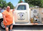 Dan "Peanuts" Kloos stands beside the 1948 fire truck he bought and plans to use for funerals of former local firemen. 