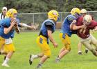 Minneota quarterback Alex Pohlen had an eye on his receivers as Mitchell Rost laid a block on a Springfield defender. The action came at the Tracy scrimmage last Saturday. The Vikings open the season at home Thursday against Sleepy Eye. 
