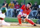 Preston Nuy (left) tried to score but was out at home as Dawson's Alex Swenson made the tap. 