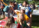 Bug Day Queen Candidate Katie Walerius paints the face of Lydia Coequyt as Jaelyn Anderson mugged in the background with Dakota Pesch behind her.