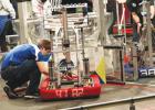 Technician Drew Lipinski positions the robot before the match.