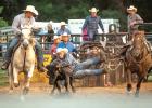 Steer wrestlers take their turn taking down livestock during the Lyon County Fair Rodeo on Thursday. This rider laid out horizontally to grab the steer by the horns. 
