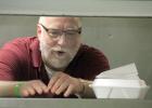 Rusty Rhymer has been looking through the grill counter for 30 years and is ready to give it up as soon as the business is sold or when he has to close it down. He puts the orders on the counter to be served to the customers, or for takeout. 