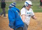 Minneota's Ava Larson smiles as she is congratulated at third base by Coach Heidi Boerboom after hitting a home run in the fifth inning of the second game against Lac qui Parle Valley on Tuesday. 
