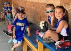 These kids waiting in the dugout to play a game enjoy wearing the Minneota colors during their Summer Rec games. 