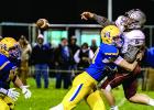 Logan Sussner put pressure on Yellow Medicine East quarterback Cody Dahlager all night long. Beau Banish came in to help (left).