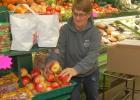 Karen Swedzinski works on re-stocking fresh apples in Brad's Market. 