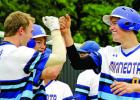 Thomas Hennen (right) hit his first varsity home run against Central MN Christian and was congratulated by Alex Pohlen.