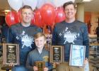 Coach Travis Christenson, Lincoln Christenson and Coach J.D. Pesch posed with their awards for the THOR Wrestling Club.