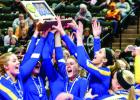 Minneota hoisted the state championship trophy after winning the title over Medford on Saturday. On the left is Sydney Larson with Lizzy Gillingham in the center and Natalee Rolbiecki and Abby Rost on the right.