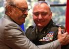 Contributed photo Troy Fink, right, is hugged by his father, Jim, after being promoted to Colonel in late October at a ceremony at Camp Ripley.