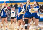 Minneota players celebrate after notching a point against Renville County West last Tuesday evening in Minneota. 