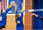 Abby Frie, left, and McKenna Yost go up for a block against CMCS on Tuesday night. 