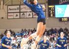 Elivia Faris of Minneota soars above the net to pound down an attack against Westbrook-Walnut Grove in the Section 3A championship on Saturday at Southwest Minnesota State University in Marshall.