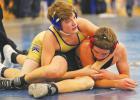 Eli Gruenes (left) of Minneota checks out the time remaining in the second period as he puts Isaac Moravetzof United in a cradle before pinning in in 3:48 on Saturday. 